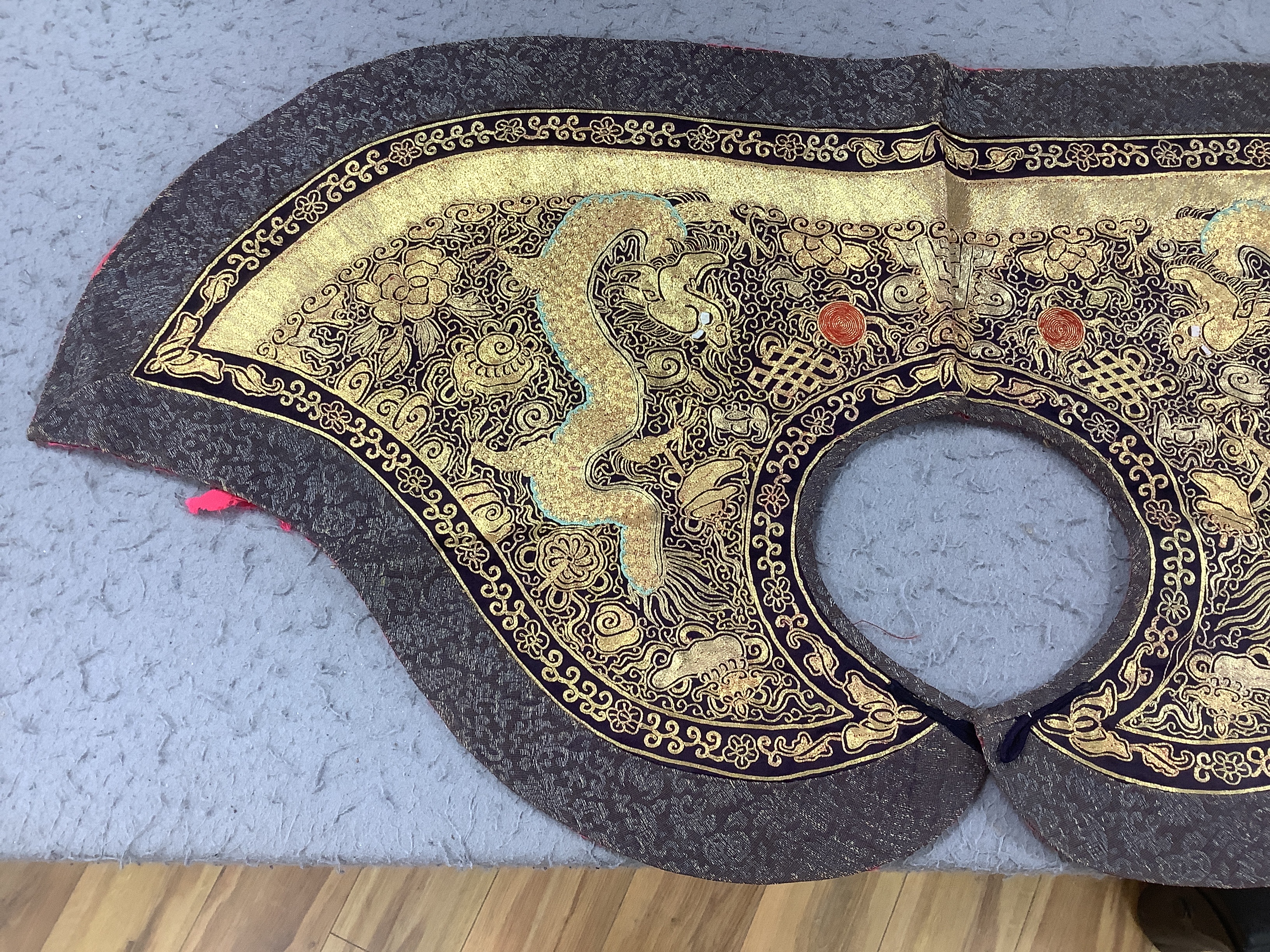 Two mid 20th century Chinese embroidered Rank Badges, a large gold thread dragon embroidered collar, three Chinese embroidered panels and a Japanese 1930’s Shantung silk dragon embroidered Kimono dressing gown